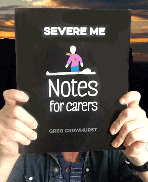 a picture of Greg holding Severe ME, Notes for Carers up
